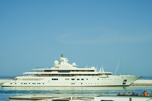 Al Raya Yacht 250M$ at the pier during 2022 Monaco F1.\nMotor yacht with a length of 110m, built by Lürssen at the Bremen shipyard, exterior design by Tim Heywood, interior design by Alberto Pinto. The owners are the Royal Family of Bahrain.