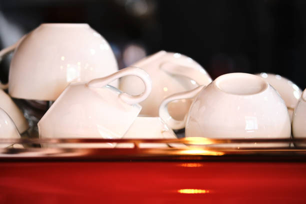 istock White mugs on a red coffee machine. Atmospheric photo. 1405931467