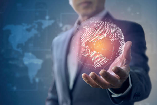 International business in a modern world Business administrator holds a virtual globe in his hand in business administrative ability concept. man holding earth stock pictures, royalty-free photos & images