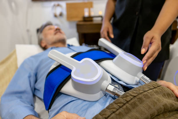 Man getting radio frequency therapy at the spa targetting his abdominal body fat