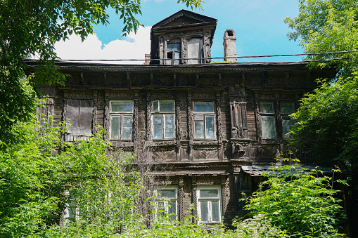 Old wooden house overgrown in Russia