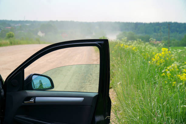 Car door. The car stopped on a dusty road