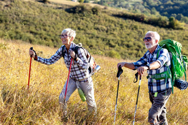 istock Active old woman and man walking at field and enjoy 1405937672