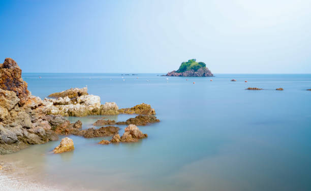 istock A small rocky island on the beach. 1405938486