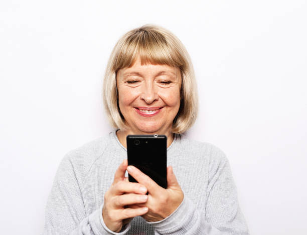 istock old woman mobile isolated smile 1405941055