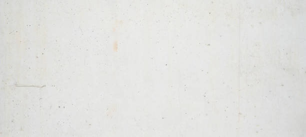 istock White grunge bright light concrete wall texture background banner 1405944413