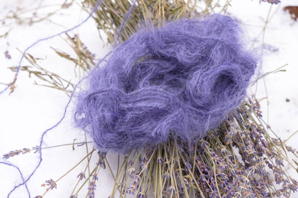 Purple mohair threads and purple lavender on a snow background. Lavender color threads.
