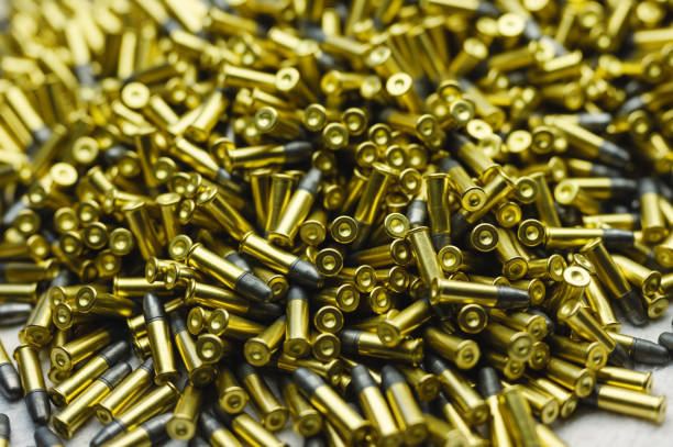 istock Small-caliber bullets on white table at production plant 1405950892