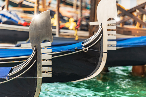 Close-up of the Prow of Two Gondolas, typical Venetian rowboat, Grand Canal (Canal Grande), UNESCO world heritage site, Venetian lagoon, Veneto, Italy, Europe.