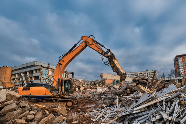 istock Excavator with hydraulic chews breaks beam of concrete 1405951008