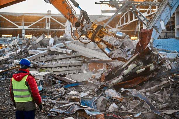 istock Excavator destroyer removes debris under worker control 1405951013