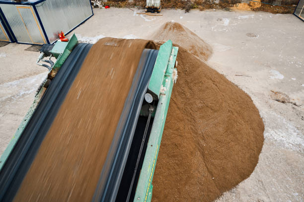 istock Soil falls from conveyor of crushing and sorting complex 1405951035