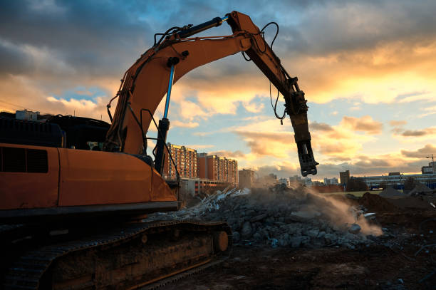 istock Excavator with concrete crusher on rig at demolition site 1405951043