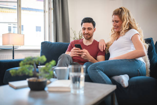 istock Handsome Young Couple Scrolling On The Phone And Laughing 1405952707