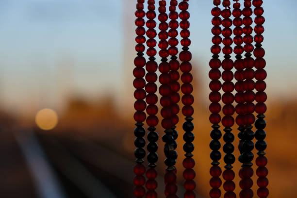 Red necklace against the evening sun. Copy space.