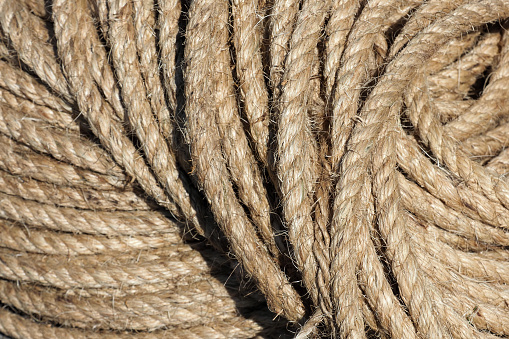 Jute hemp rope rolled into a coil. Brown weave threads