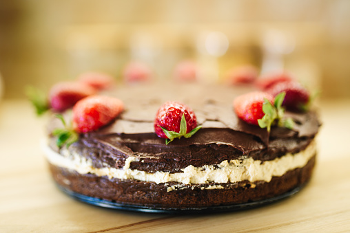Chocolate cake decorated strawberries and cream