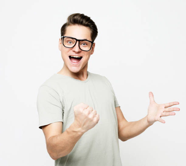 istock Happy young handsome man gesturing and keeping mouth open over white background 1405959307