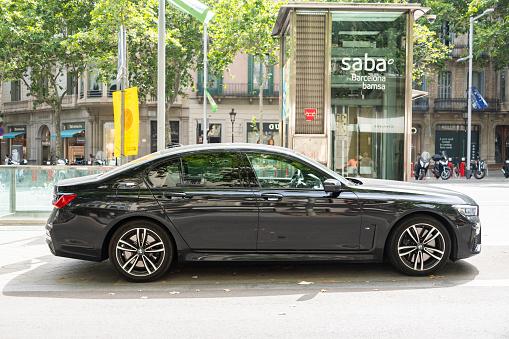 Barcelona, Spain - 20 June 2022: Side view of a BMW 7 series in a street of Barcelona, Spain