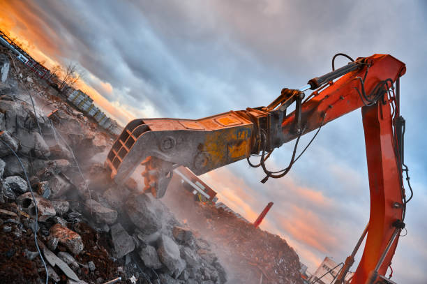 istock Excavator with concrete crusher on rig at demolition site 1405961107