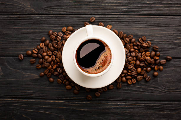 istock Coffee with beautiful foam with coffee beans on black boards 1405962386