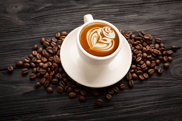 istock Coffee with beautiful foam with coffee beans on black boards 1405962391