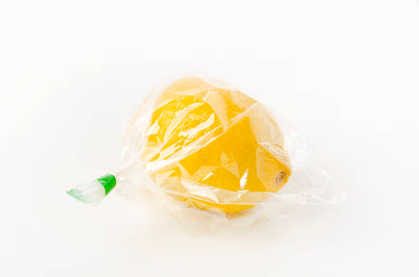 istock fresh lemon in plastic bag on white background. Tropical fruits. 1405964646