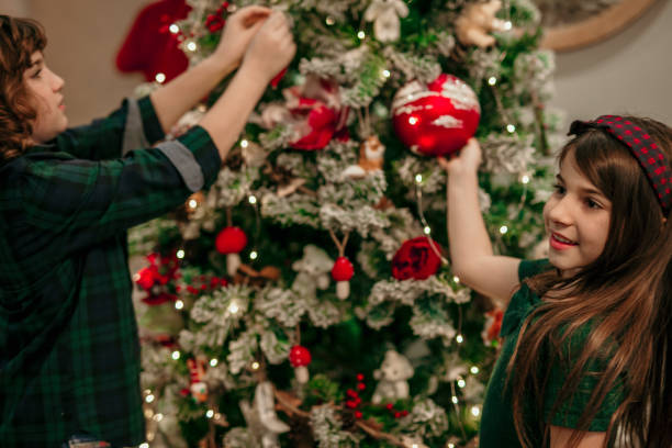 istock Family Christmas decorating tree moment 1405967658