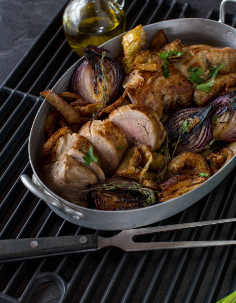 Oven roasted pork tenderloin with onions stock photo