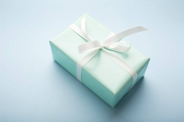istock Present boxes on blue background greeting card holidays concept. 1405969259