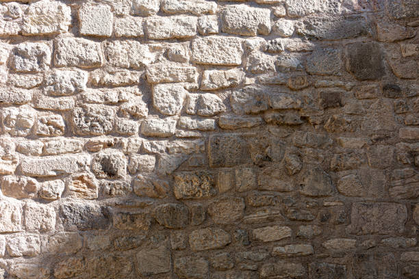 istock Three-dimensional texture of the old stone wall. 1405970564