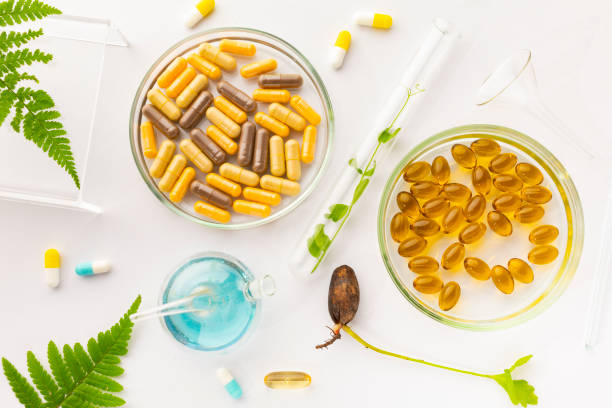 istock Test tubes with plants in a holder, vitamins on a light background, laboratory 1405972064