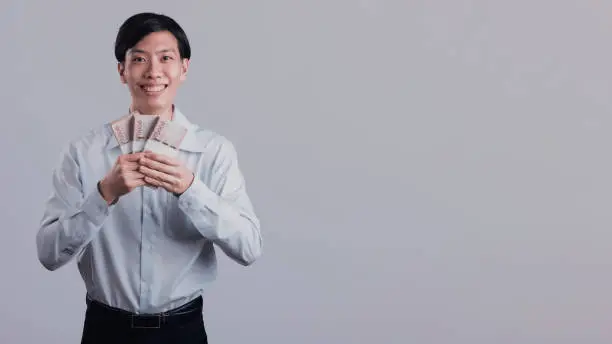 Photo of Career man holding money in hand.