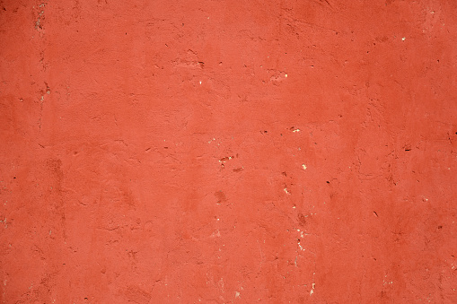 Red plastered rusty concrete wall