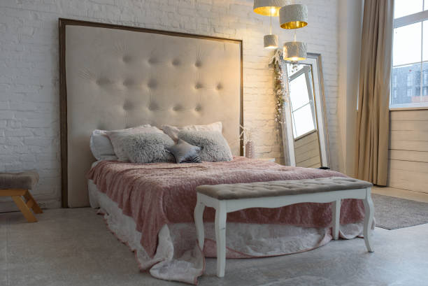 istock Comfortable bed with pillows in room. Stylish interior design 1405974796