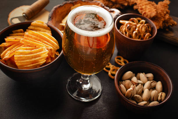 istock bottle of beer and different snacks on rustic wooden table. Top view 1405974927