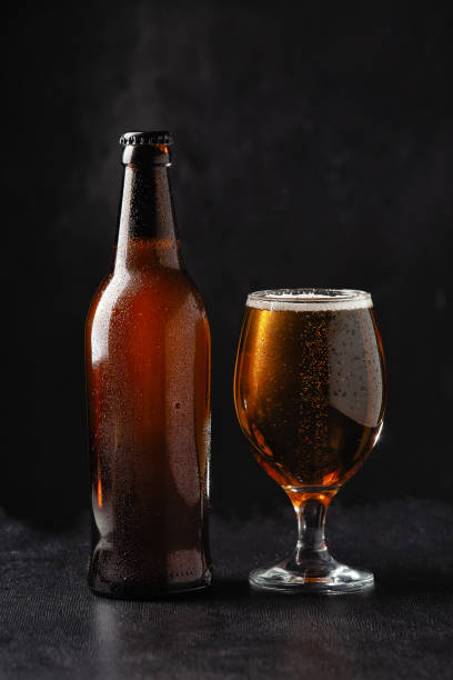 istock alcoholic drinks, beer with foam isolated on black background. 1405974961