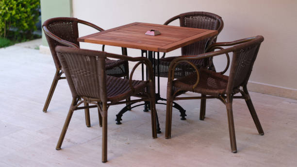 istock Summer wooden table and wicker chairs on veranda 1405975324