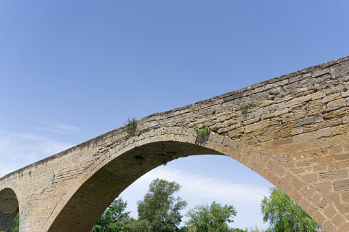 Close-up of the arch of an old stone bridge