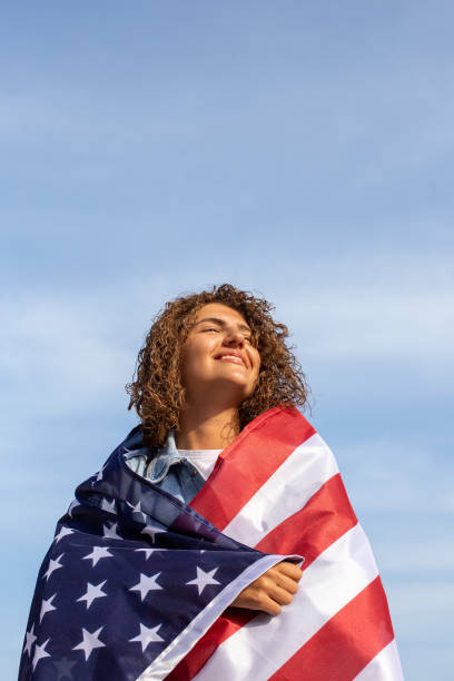 istock Slim beautiful woman holding USA flag 1405977498