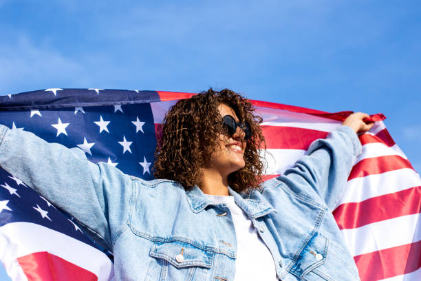 istock Slim beautiful woman holding USA flag 1405977667