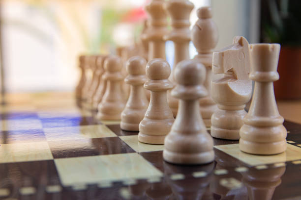 istock Wooden chess pieces on the board close-up. 1405978370