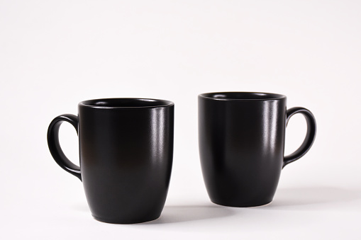 Black porcelain coffee cups on the white background