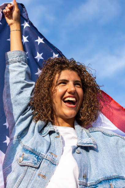 istock Slim beautiful woman holding USA flag 1405979051
