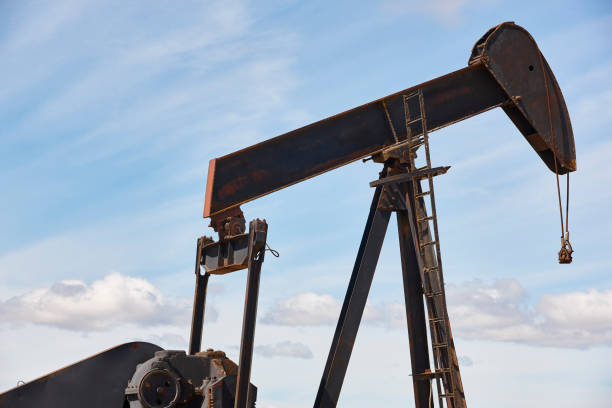 istock Oil pumping machine. Pump jack. Petroleum extraction. Global warming 1405979180