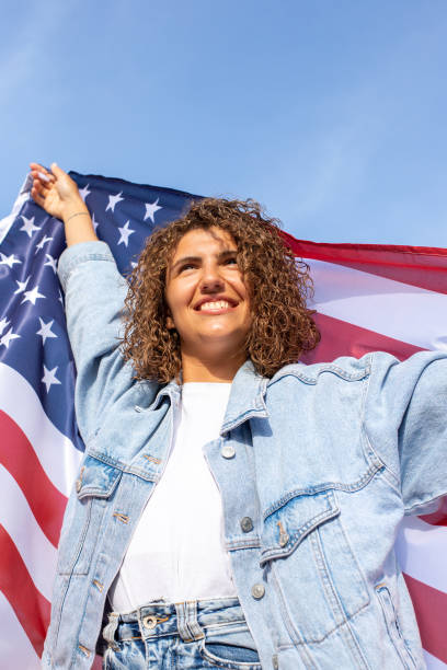 istock Slim beautiful woman holding USA flag 1405979335