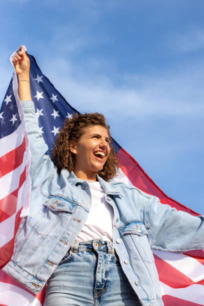 istock Slim beautiful woman holding USA flag 1405979604