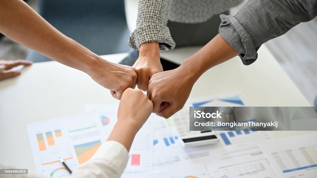 A group of successful businesspeople making fist bump together A group of successful businesspeople making fist bump together to cheer up, support and making a team spirit in the meeting. close-up image Fist Bump Stock Photo