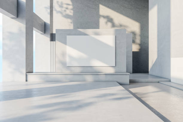 istock Front view on blank white banner on light grey wall in sunlit spacious hall with concrete design. 3D rendering, mockup 1405983133