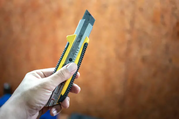 Photo of Holding a cutter tool - working and object.